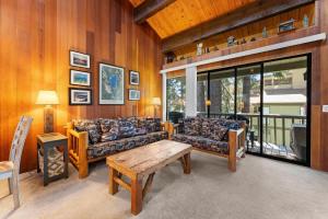 a living room with two couches and a table at Twisted Retreat in Kings Beach