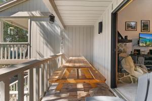 a wooden bench on the porch of a house at Twisted Retreat in Kings Beach