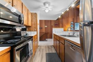 a kitchen with wooden cabinets and a stove top oven at Twisted Retreat in Kings Beach +25 photos