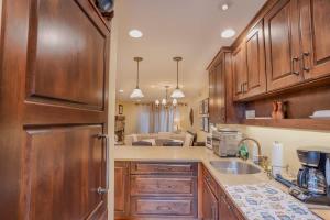 a kitchen with wooden cabinets and a sink and a refrigerator at Beach-N-Ski Condo in Tahoe Vista