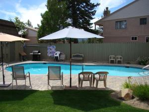 a group of chairs and an umbrella next to a pool at Beach-N-Ski Condo in Tahoe Vista +29 photos