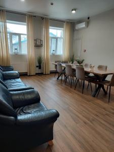 a living room with a couch and a table and chairs at Hotel GLORIA in Ceadîr-Lunga