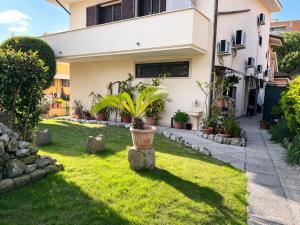 a house with a potted plant in the yard at Il Borghetto in Ciampino