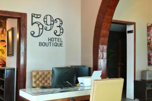a room with a table and a sign on the wall at 593 Hotel Boutique Baños in Baños +16 photos