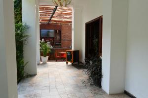 an entrance to a room with a hallway with plants at 593 Hotel Boutique Baños in Baños