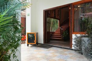 an entrance to a house with a sign on the door at 593 Hotel Boutique Baños in Baños