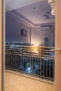 a balcony with a view of the city at night at StayScape studio in Greater Noida