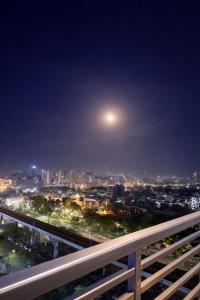 a view of a city at night with a moon at StayScape studio in Greater Noida