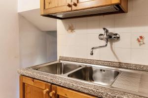 a kitchen sink with a faucet on top of it at Chalet Tessa BELLAGIO in Bellagio +32 photos