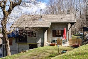 a house on a hill with a red umbrella at Chalet Tessa BELLAGIO in Bellagio