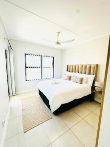 a bedroom with a large bed in a room at Spacious 3 Bedroom Apartment in Ballito Hills Lifestyle Estate Near Ballito Beach in Ballito +32 photos