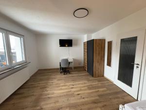 an empty room with a desk and a window at Gästehaus GAP in Dietlingen +46 photos