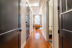 a hallway of a home with a door and wooden floors at The Saint Clair in Frankfort +9 photos