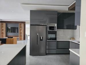a kitchen with a stainless steel refrigerator at VnA Executive Suites in Pretoria