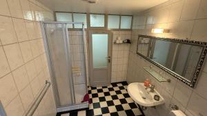 a bathroom with a sink and a shower at City B&B Cochem in Cochem +30 photos