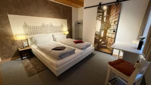 a bedroom with a white bed with a picture on the wall at City B&B Cochem in Cochem