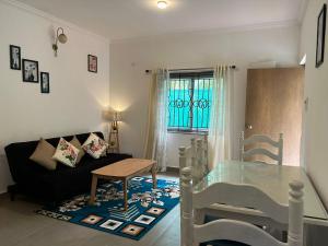 a living room with a glass table and a couch at Marshmallow - by MA Homes in Morjim