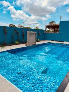 a large swimming pool with blue water at Pousada Serena - Alter do Chão in Santarém