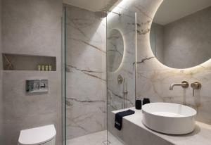 a bathroom with a sink and a shower at Phos Luxury Living in Sarti +75 photos