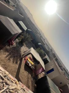 an overhead view of a beach with a building and the sun at Traditional nomad camp in Merdani