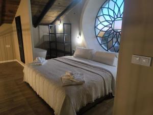 a bedroom with a large bed with a window at Hacienda La Celada CARMONA SEVILLA in La Celada +44 photos