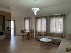 a living room with a couch and a table at Olivea Suites Tirana in Tirana