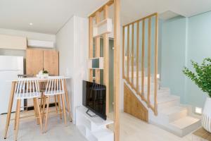 a small kitchen and staircase in a home with white walls at Hibiscus Suites in Potos