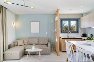 a living room and kitchen with a couch and a table at Hibiscus Suites in Potos +19 photos