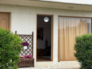 a front door of a house with a window at Villa Apollonia Guest House in Fier