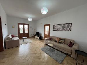a living room with a couch and a table at Villa Apollonia Guest House in Fier +78 photos