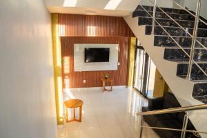 ein Flur mit einer Treppe und einem Fernseher an der Wand in der Unterkunft Hotel Bimini in Constanza