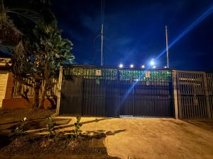 a black fence with lights on top of it at Alojamiento Cereza 2 in Alajuela