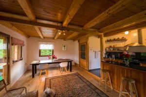 a kitchen and dining room with a table and chairs at Chalet M 1 in Lunca Bradului