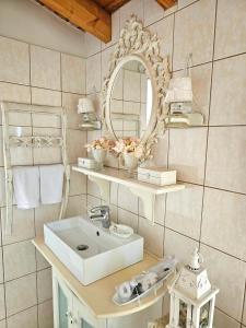 a bathroom with a sink and a mirror at Sophy's Cottage in Politika +60 photos