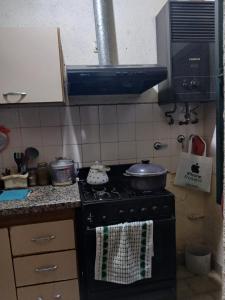 a kitchen with a stove with pots and pans on it at Las Gemelas in Rosario