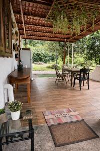 a patio with a table and chairs under a pergola at Amancay House, Jacuzzi and Pool in San Cristóbal +25 photos