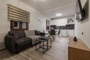 a living room with a couch and a table at Casa Calma in Volos