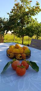two baskets of lemons and tomatoes on a table at Zagrljaj prirode in Blagaj