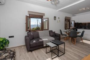 a living room with a couch and a table at Casa Calma in Volos