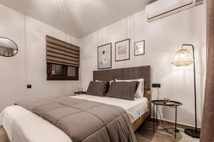a bedroom with a large bed and a lamp at Casa Calma in Volos