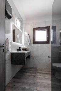 a bathroom with a sink and a toilet at Casa Calma in Volos +55 photos
