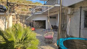 a patio with a swing in a house at Guest house Boljević in Rap