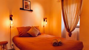 a bedroom with a bed with shoes on it at Dubonnet - Cœur de ville in Brignoles +7 photos