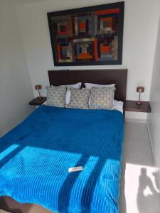 a bedroom with a blue bed with a blue comforter at Maison vue mer a 5 min de MONACO in Roquebrune-Cap-Martin