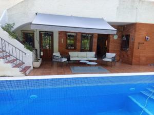 a house with a swimming pool next to a building at Casa Azahar in Lliria