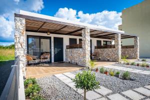 a home with a patio with a stone wall at Odaria Premium Apartments in Lampi