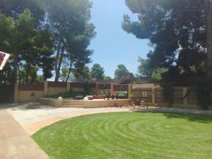 a backyard with a retaining wall and a lawn at Casa Azahar in Lliria +54 photos