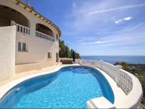 a swimming pool on the side of a house at Altea Hills Best Seaview in Altea