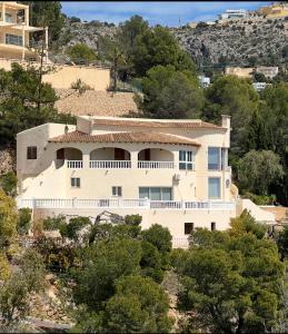 a large white house on a hill with trees at Altea Hills Best Seaview in Altea