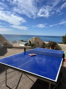 a blue ping pong table with a tennis racket on it at Altea Hills Best Seaview in Altea